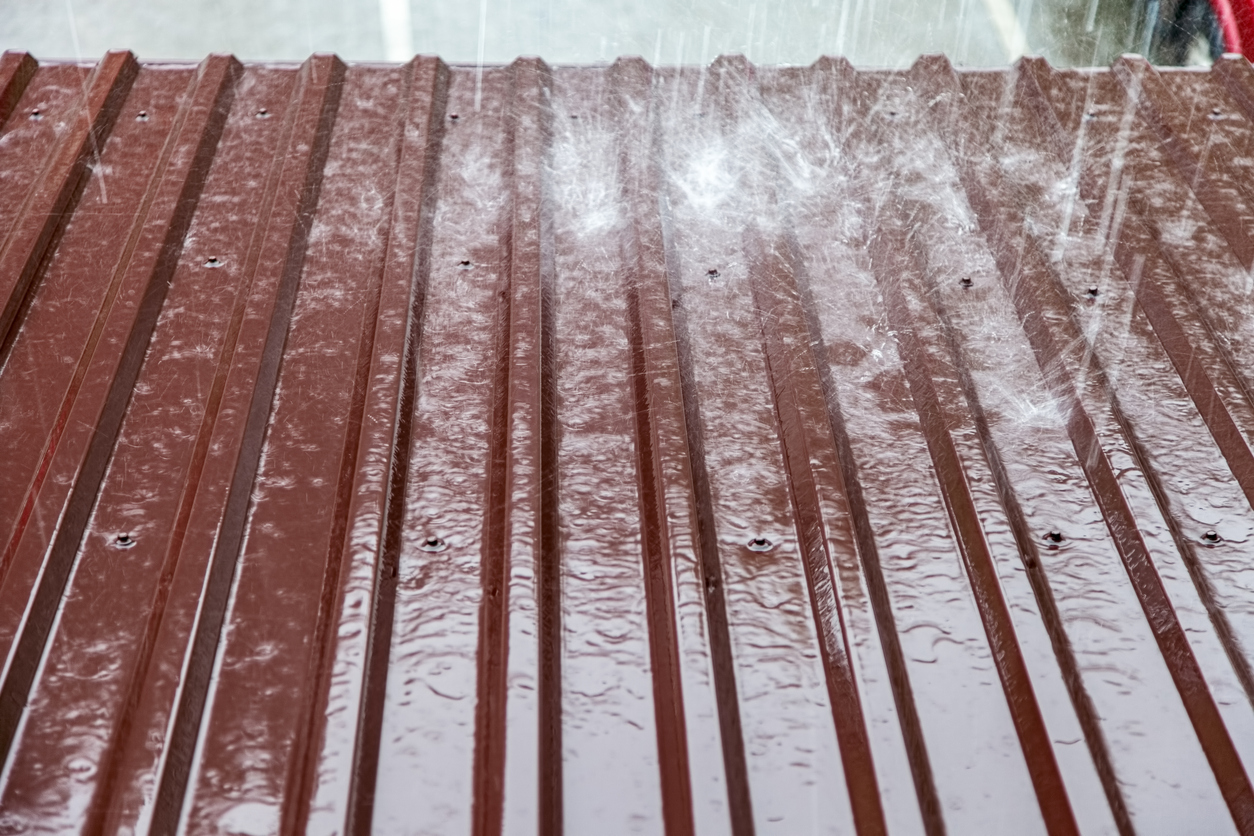 The surface of the metal roof during heavy rain