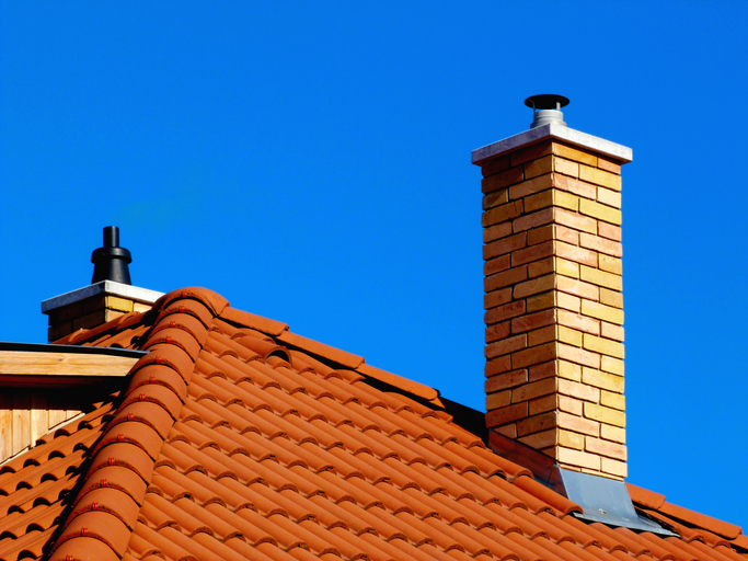 yellow brick chimney and light brown clay tile roof