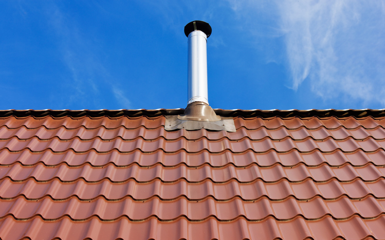 Red tile roof with a tin chimney