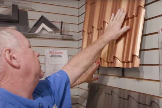 worker showing customer metal roofing