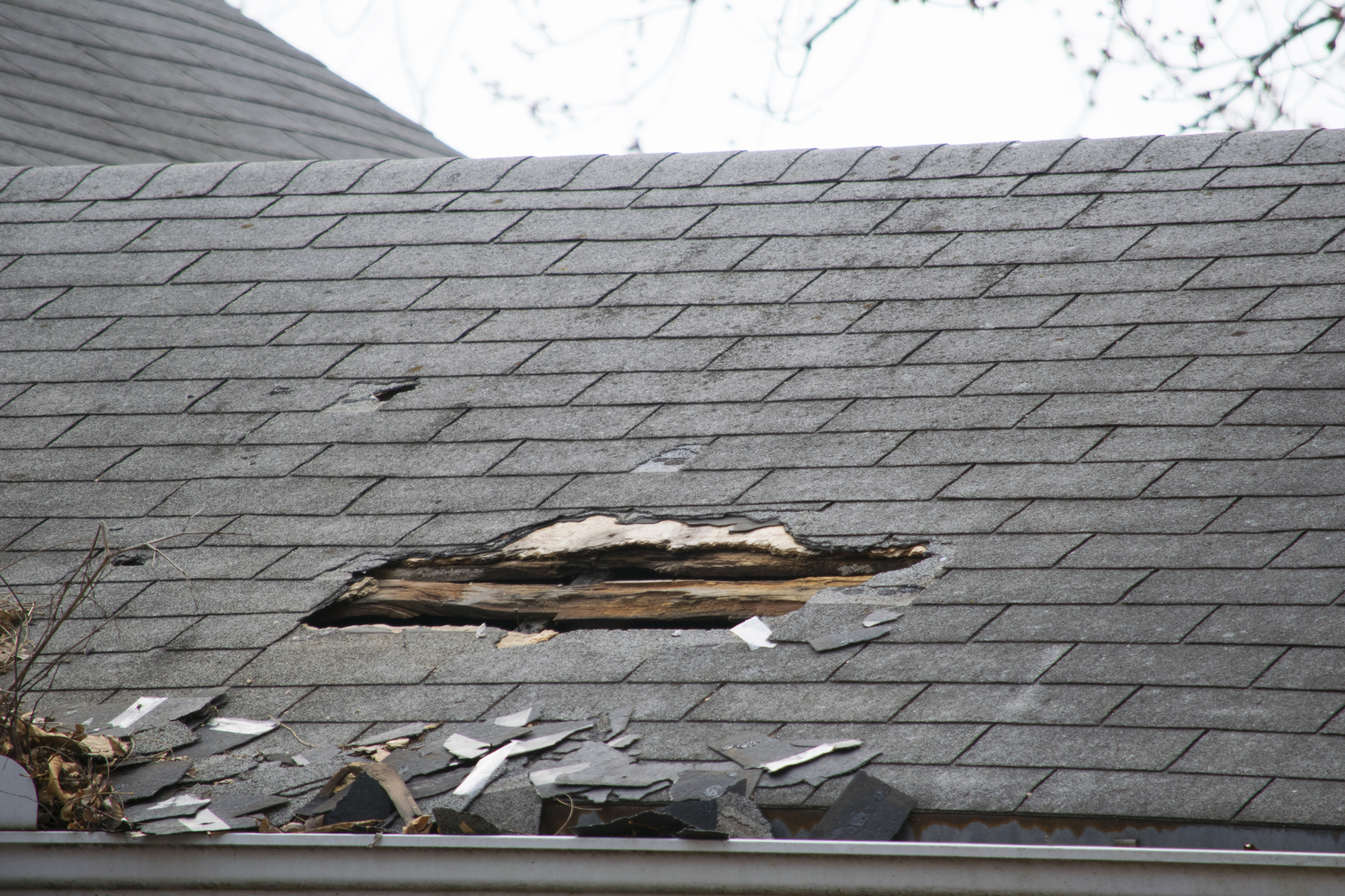 Damaged and old roofing shingles on a house